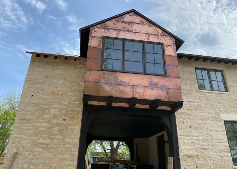 Copper metal panel facade on a stone building for Skylight Installation in Cortlandville